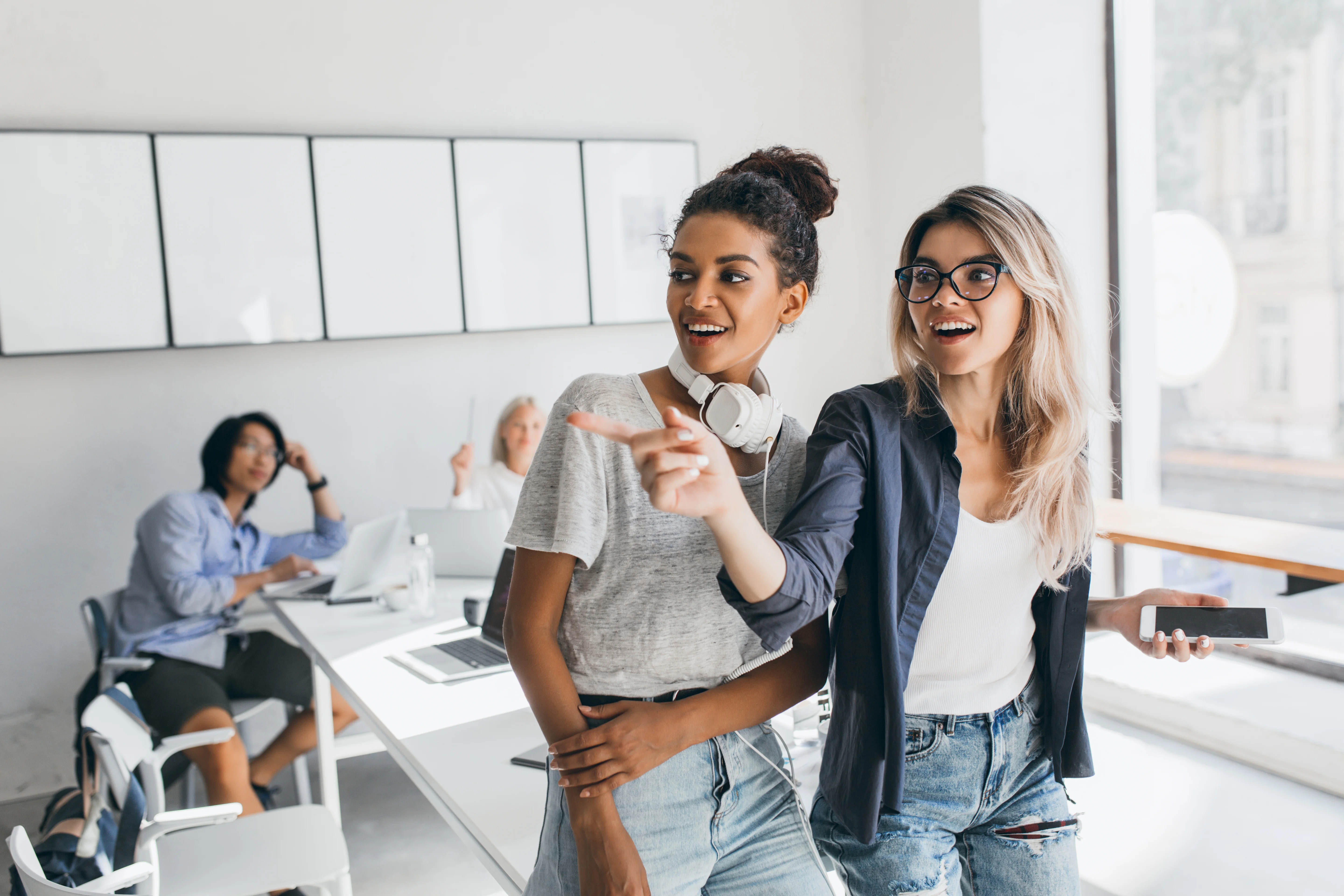 african-business-lady-casual-attire-looking-away-while-talking-with-blonde-colleague-glasses-portrait-asian-programmer-working-with-laptop-black-curly-girl.jpg